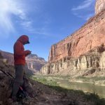 Peaches staring at his phone in the Grand Canyon