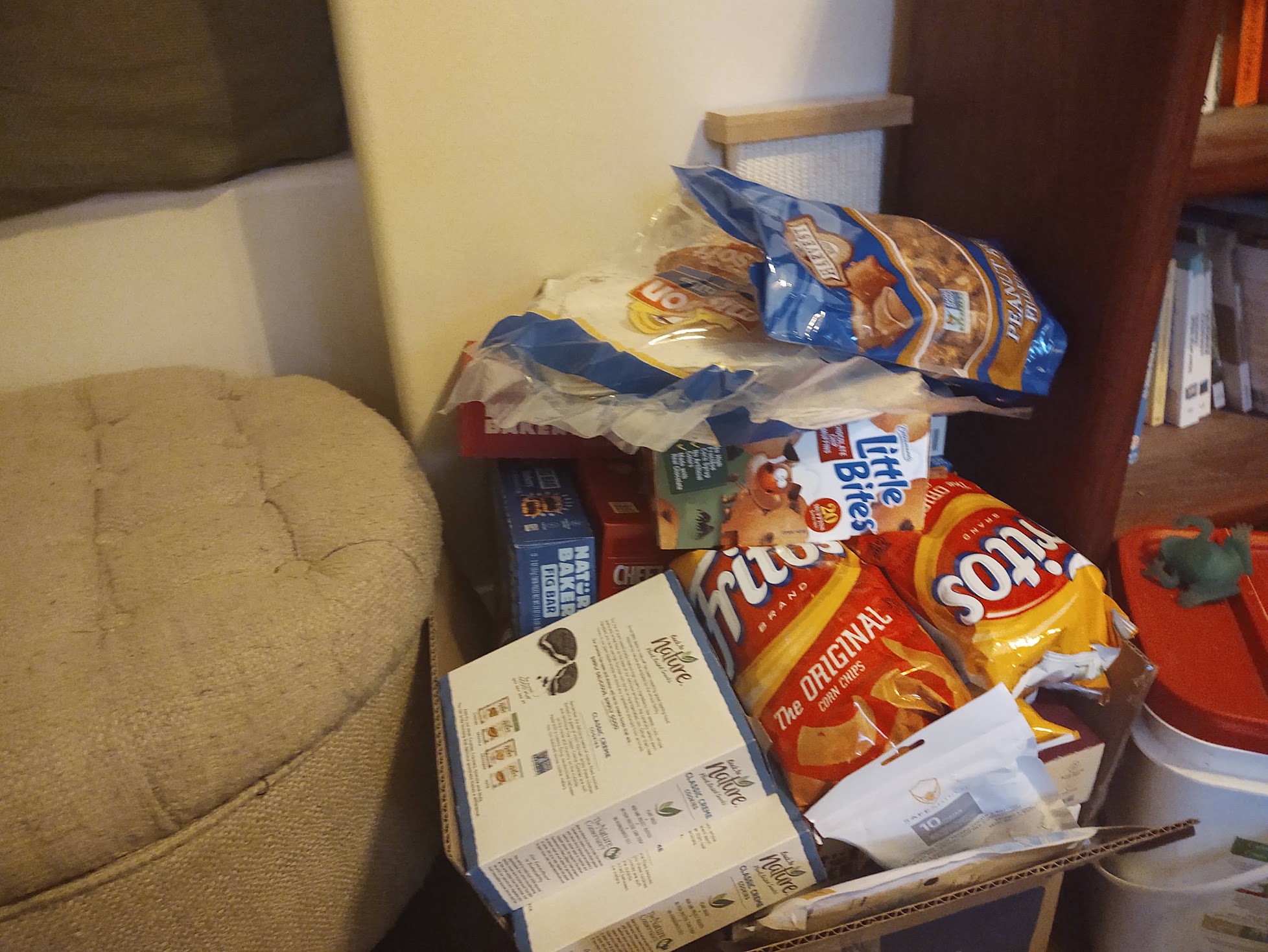 Pile of hiker food including Fritos, Little Bites, and Nature's Bakery bars before a resupply