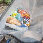 Trail food including Fritos and crackers packed in a dry bag